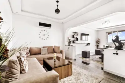 a living room with a couch and a table at Magnifique appartement en plein centre ville in Marrakech