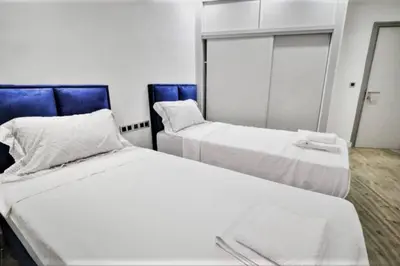 a room with two beds and a mirror at Magnifique appartement en plein centre ville in Marrakech