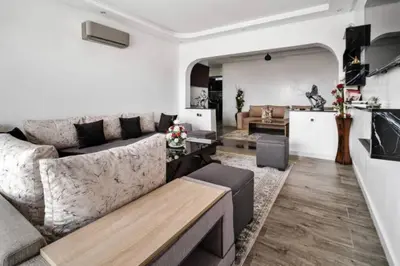 a living room with a couch and a table at Magnifique appartement en plein centre ville in Marrakech