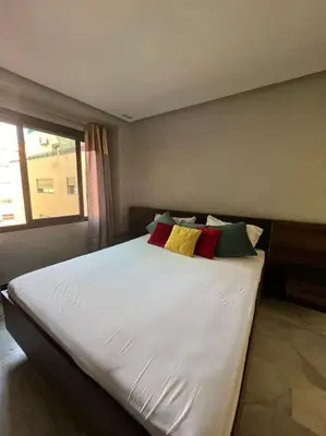 a bedroom with a large white bed with colorful pillows at Vitality Harmony A27 in Marrakech