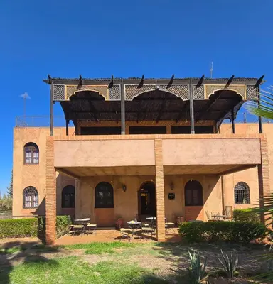 a brick building with a balcony on top of it at Riad Mhidou Marrakech in Marrakech