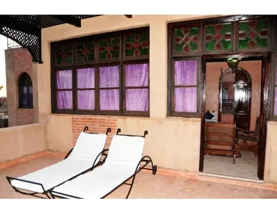 a couple of chairs sitting on a porch at Riad Mhidou Marrakech in Marrakech