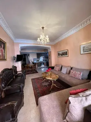a living room with a couch and a table at 1 Bed Flat - Sleeps 2 - Parking - Wifi in Marrakech