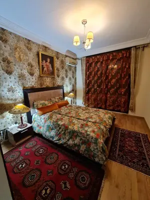 a bedroom with a bed and a red rug at 1 Bed Flat - Sleeps 2 - Parking - Wifi in Marrakech