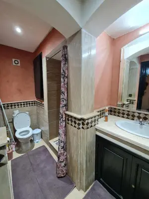 a bathroom with a toilet and a sink at 1 Bed Flat - Sleeps 2 - Parking - Wifi in Marrakech