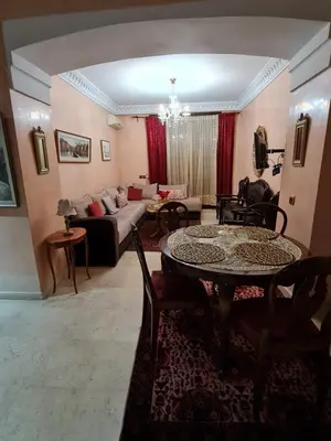 a living room with a table and a couch at 1 Bed Flat - Sleeps 2 - Parking - Wifi in Marrakech