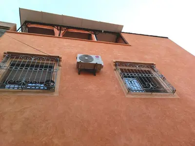 a building with two windows and a table on it at Oasis appart sérénité in Marrakech