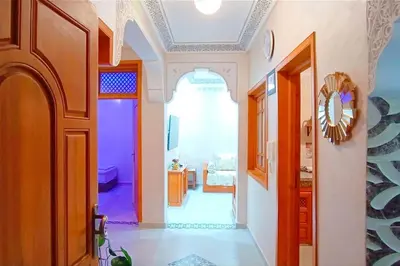 a hallway of a home with an archway and a room at Oasis appart sérénité in Marrakech