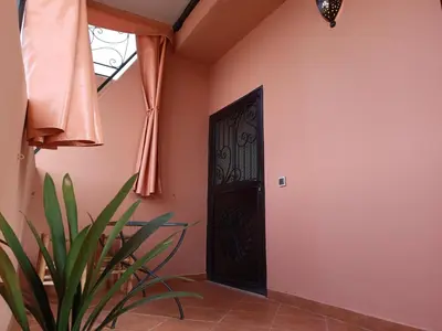 a door in a room with a plant next to it at Studio l'Oasis de la Palmeraie in Marrakech