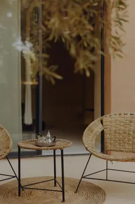 a table and two chairs and a table and chairs at Les Jardins de Kesali By La Siredrah in Marrakech