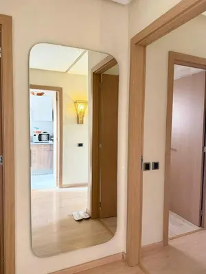 a large mirror in a room with a door at Marrakech Prestigia appartement vue piscine golf endroit calme in Marrakech