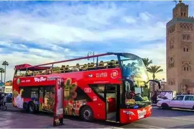 a red double decker bus parked in a parking lot at Marrakech Prestigia appartement vue piscine golf endroit calme in Marrakech