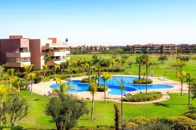 an aerial view of a resort with a pool at Marrakech Prestigia appartement vue piscine golf endroit calme in Marrakech