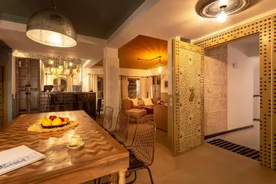 a dining room with a table and a living room at LES TANNEURS PENTHOUSE MARRAKECH in Marrakech