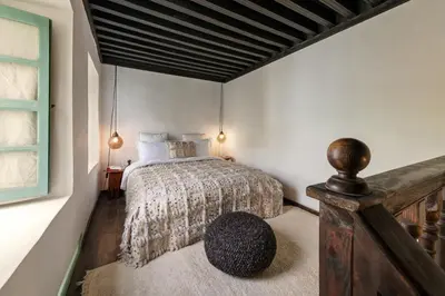 a bedroom with a bed and a window at Riad Kitula in Marrakech