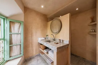 a bathroom with a sink and a mirror at Riad Kitula in Marrakech