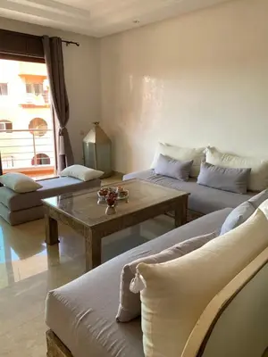 a living room with two couches and a coffee table at Résidence Las Palmeras in Marrakech