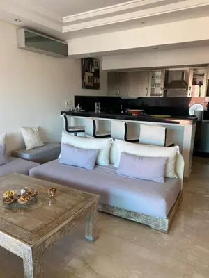 a living room with a couch and a table at Résidence Las Palmeras in Marrakech