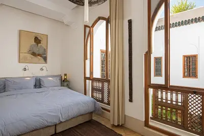 a bedroom with a bed and a large window at Riad Rossi in Marrakech
