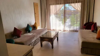a living room with a couch and a coffee table at Hôtel Jardins de lina et lea in Marrakech