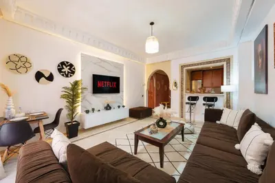 a living room with a couch and a table at Appartement Chic Gueliz Plaza avec Vue in Marrakech