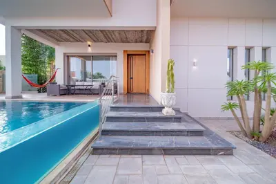 a villa with a swimming pool and a house at Villa moderne avenue M6 in Marrakech