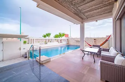 a house with a swimming pool and a patio at Villa moderne avenue M6 in Marrakech