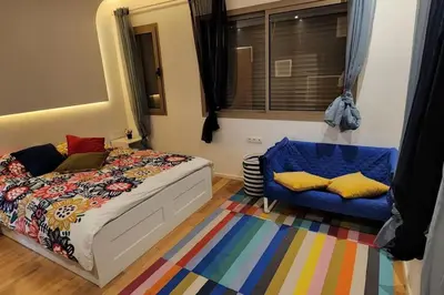 a bedroom with a bed and a blue chair at Villa moderne avenue M6 in Marrakech