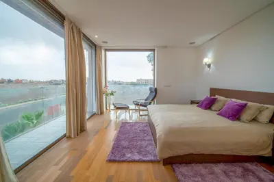 a bedroom with a large bed and a large window at Villa moderne avenue M6 in Marrakech