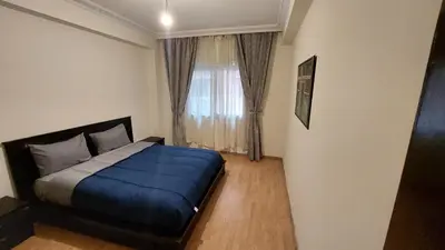 a bedroom with a blue bed and a window at Cosy apartment in Marrakesh, Guliz in Marrakech