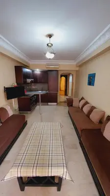 a large living room with a couch and a kitchen at Cosy apartment in Marrakesh, Guliz in Marrakech
