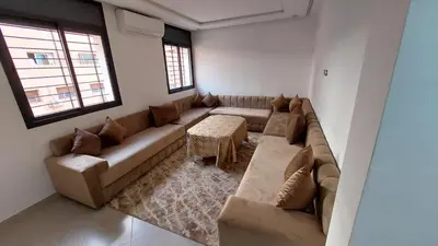 a living room with a couch and a table at New Apartment in Marrakesh Guliz in Marrakech
