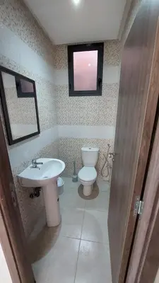 a bathroom with a sink and a toilet and a window at New Apartment in Marrakesh Guliz in Marrakech