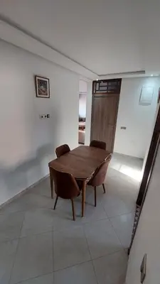 a dining room with a wooden table and chairs at New Apartment in Marrakesh Guliz in Marrakech