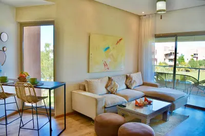 a living room with a couch and a table at Appartement, Prestigia Marrakech in Marrakech