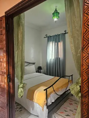 a bedroom with a bed and a large mirror at Riad Latifa in Marrakech