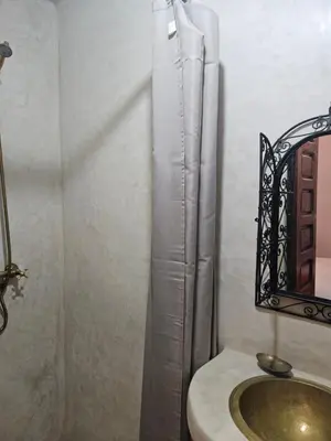 a bathroom with a sink and a toilet and a mirror at Riad Latifa in Marrakech