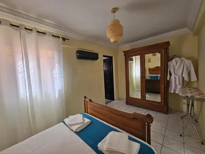 a bedroom with a bed and a mirror and a dressing room at Riad Latifa in Marrakech
