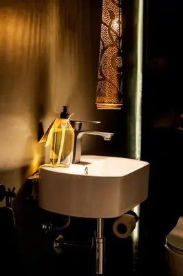 a bathroom sink with a soap bottle on it at Cosy Appartement 5min de Majorelle in Marrakech