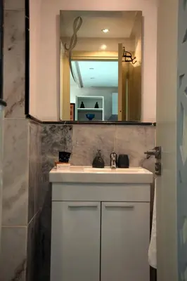 a bathroom with a white sink and a mirror at Central Marrakech Stay Bright & Airy with Scenic Gueliz location in Marrakech