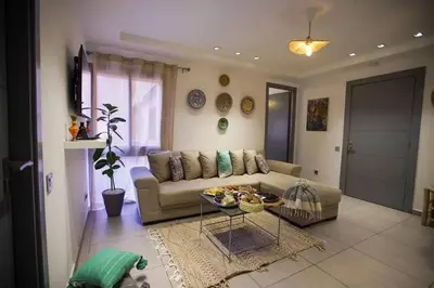 a living room with a couch and a table at Charming Cozy 2 Bedrooms central Gueliz in Marrakech