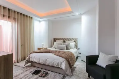 a bedroom with a large bed and a couch at Chic Hideaway - Marrakech Centre in Marrakech