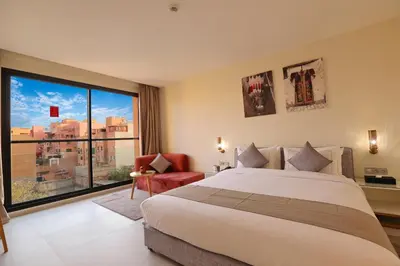 a bedroom with a large bed and a large window at Ari Boutique Hôtel - Adult Only in Marrakech
