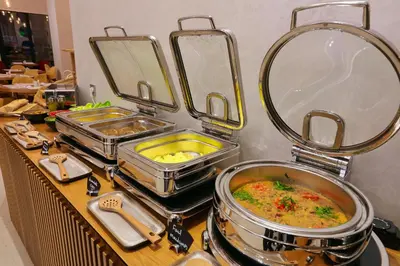 a buffet with several pans of food on a counter at Ari Boutique Hôtel - Adult Only in Marrakech