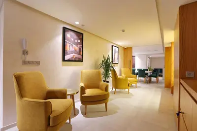 a waiting room with yellow chairs and a table at Ari Boutique Hôtel - Adult Only in Marrakech