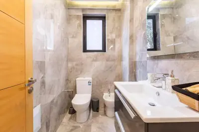 a bathroom with a toilet and a sink at Loft Duplex Familial 200m2 Neuf - Centre Gueliz in Marrakech