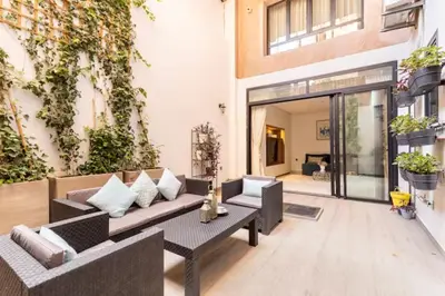 a patio with a couch and a table at Loft Duplex Familial 200m2 Neuf - Centre Gueliz in Marrakech