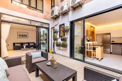 a living room with a couch and a table at Loft Duplex Familial 200m2 Neuf - Centre Gueliz in Marrakech
