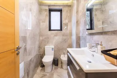 a bathroom with a toilet and a sink at Loft Duplex Familial 200m2 Neuf - Centre Gueliz in Marrakech