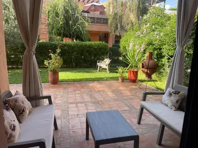 a patio with two chairs and a table at Atlas golf resort in Marrakech